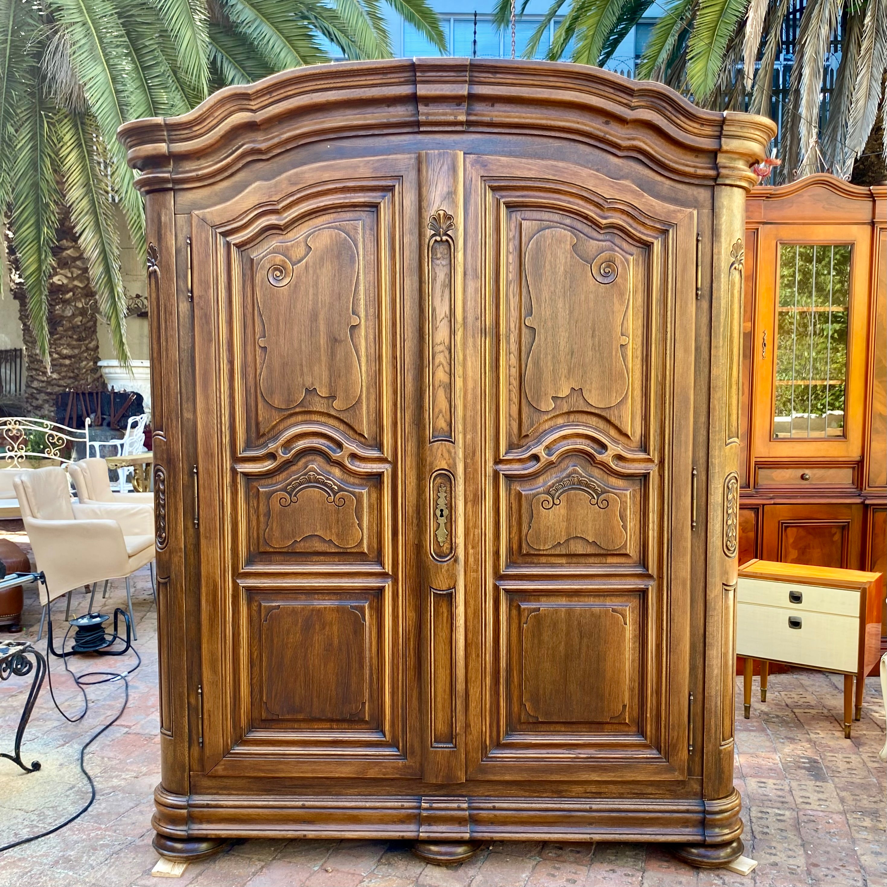 Antique Walnut Armoire with Intricate Carved Details